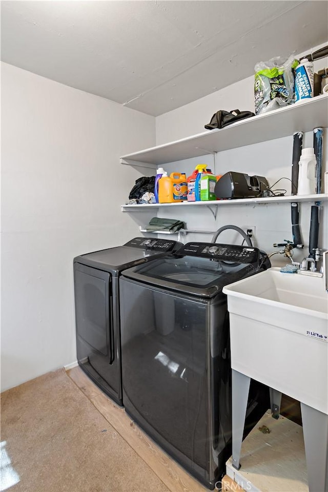 washroom featuring washer and clothes dryer and laundry area