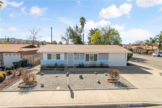 single story home featuring fence and concrete driveway