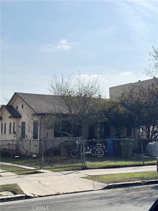 view of front of home with a fenced front yard and stucco siding