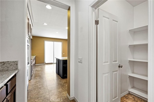 corridor with recessed lighting and baseboards