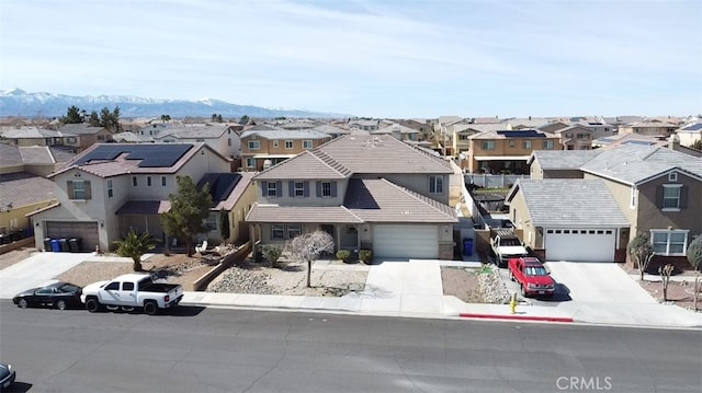 drone / aerial view featuring a residential view and a mountain view