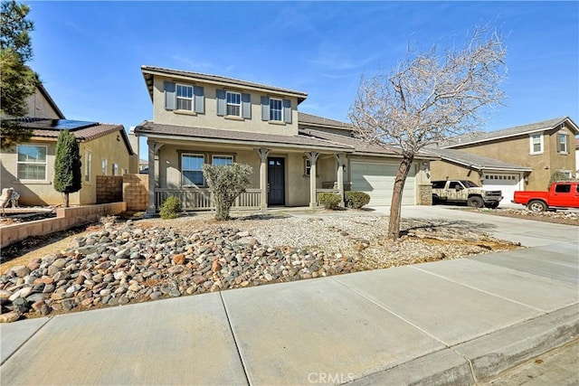 view of front facade featuring a garage, covered porch, driveway, and stucco siding