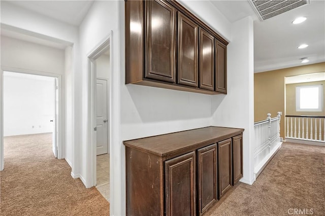 hallway featuring recessed lighting, visible vents, and light colored carpet