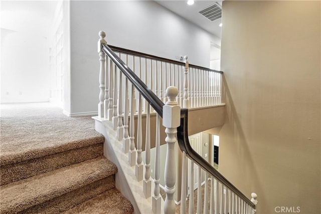 stairs featuring recessed lighting, carpet floors, a towering ceiling, visible vents, and baseboards