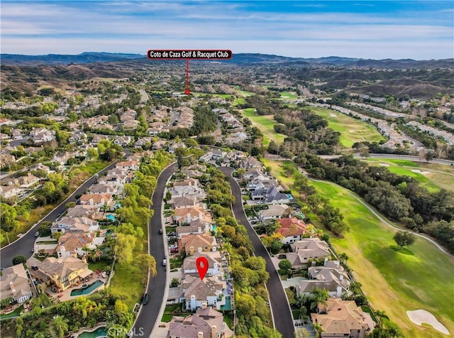 birds eye view of property featuring a residential view, a mountain view, and golf course view