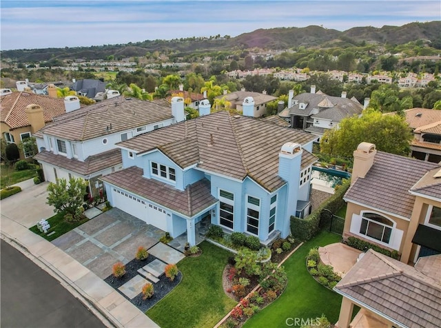 drone / aerial view featuring a residential view and a mountain view