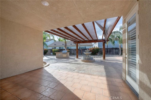 view of patio / terrace featuring exterior kitchen and fence