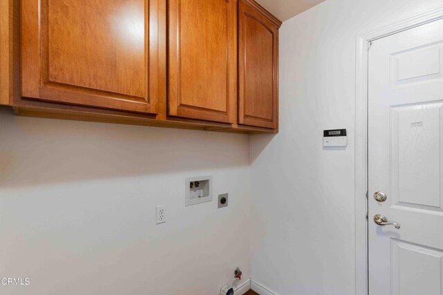 laundry room with hookup for a washing machine, cabinet space, gas dryer hookup, electric dryer hookup, and baseboards