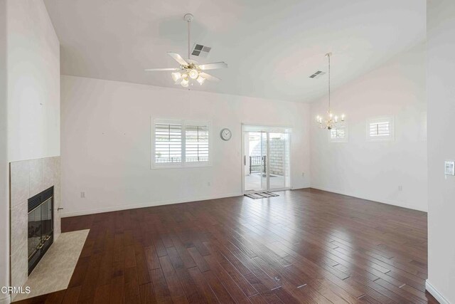 unfurnished living room featuring lofted ceiling, a fireplace, dark wood-style floors, and visible vents