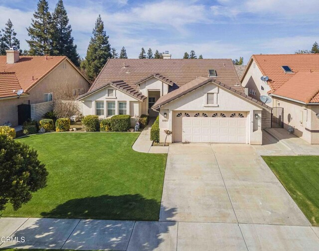 view of front of house featuring an attached garage, a tile roof, driveway, stucco siding, and a front yard