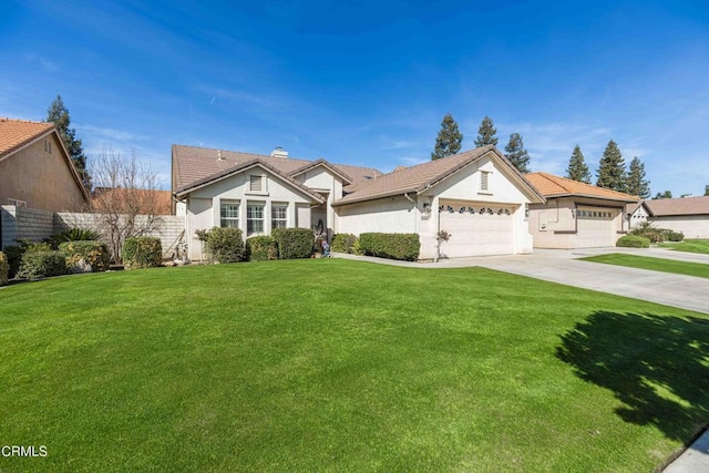 view of front of home featuring a garage, concrete driveway, fence, a front yard, and stucco siding