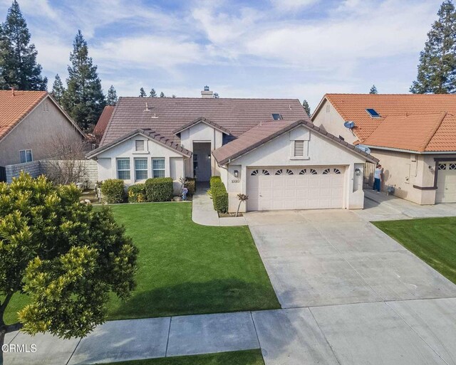 view of front of house featuring driveway, a garage, a tiled roof, a front lawn, and stucco siding