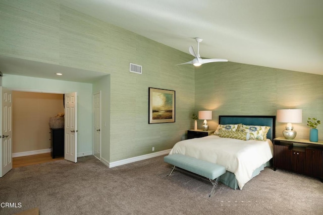 bedroom with wallpapered walls, baseboards, vaulted ceiling, and light colored carpet