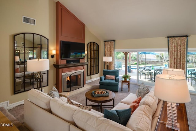 living area featuring a lit fireplace, carpet floors, visible vents, and baseboards