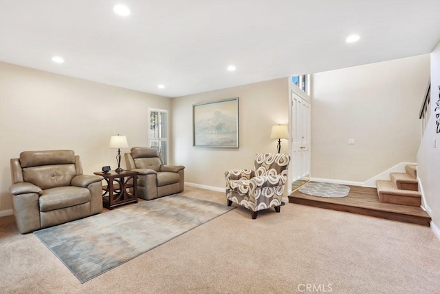 living area with recessed lighting, light colored carpet, stairway, and baseboards