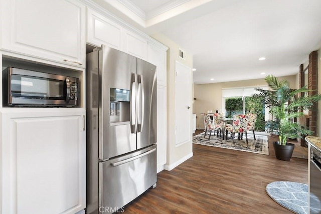 kitchen with white cabinets, visible vents, stainless steel appliances, and dark wood finished floors