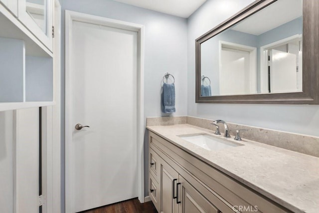 bathroom featuring wood finished floors and vanity