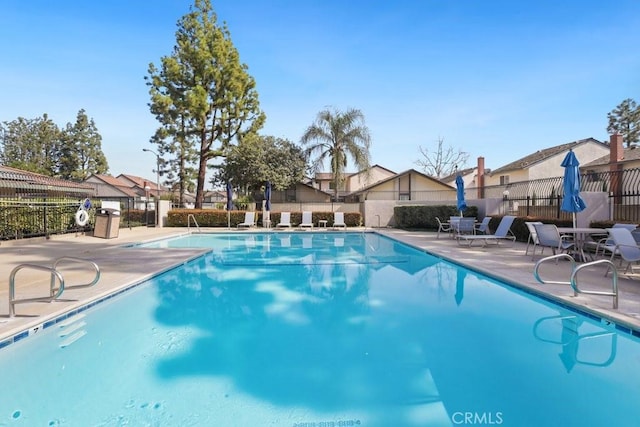 pool with a residential view and fence