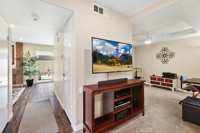 hallway featuring baseboards, visible vents, wood finished floors, and recessed lighting