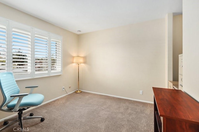 home office with light carpet and baseboards