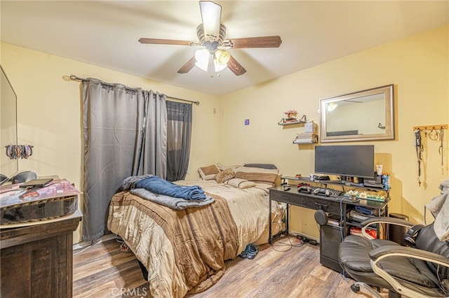 bedroom featuring ceiling fan and wood finished floors