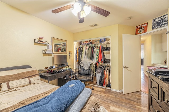 bedroom featuring ceiling fan, light wood finished floors, a closet, and visible vents