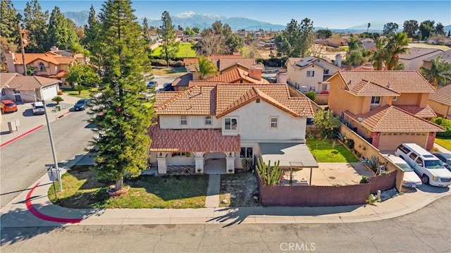 drone / aerial view featuring a residential view and a mountain view