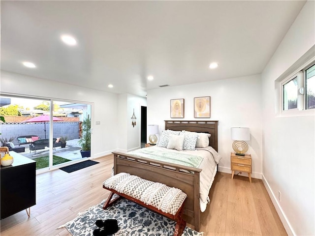 bedroom with access to outside, recessed lighting, light wood-type flooring, and baseboards