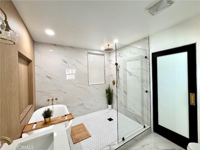 full bathroom with marble finish floor, a marble finish shower, recessed lighting, a soaking tub, and visible vents