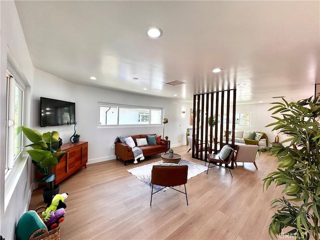 living room featuring visible vents, recessed lighting, light wood-style flooring, and baseboards