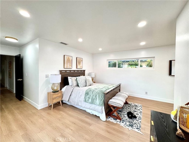 bedroom with recessed lighting, light wood-type flooring, visible vents, and baseboards