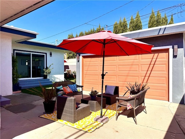 view of patio / terrace with a garage and an outdoor living space