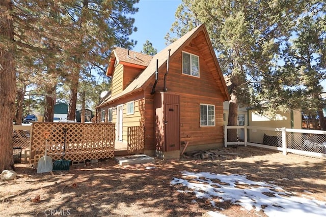 back of house with fence and a deck