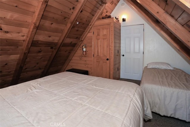 carpeted bedroom with vaulted ceiling with beams and wood ceiling