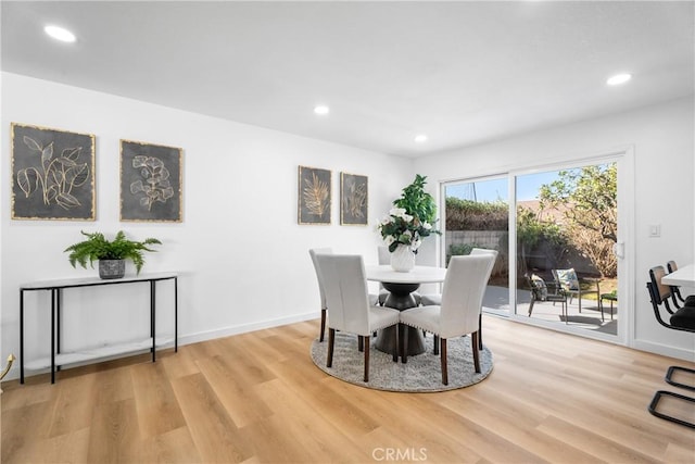 dining space featuring recessed lighting and light wood-style flooring