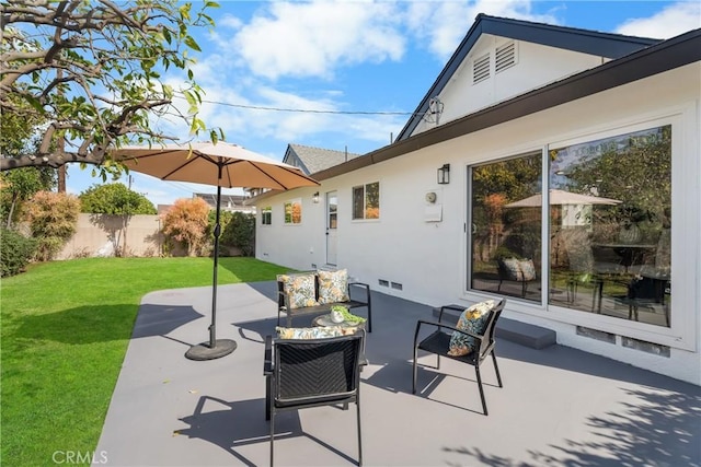 view of patio / terrace featuring outdoor lounge area, fence, and visible vents