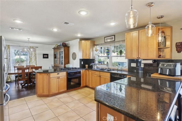 5020 Solitude Ct, Rancho Cucamonga, CA 91737 - kitchen with a peninsula, black appliances, healthy amount of natural light, a sink, and recessed lighting