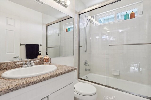 5020 Solitude Ct, Rancho Cucamonga, CA 91737 - full bathroom with vanity, toilet, and bath / shower combo with glass door