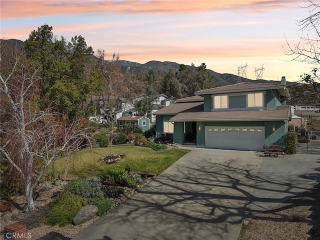 5020 Solitude Ct, Rancho Cucamonga, CA 91737 - traditional-style house with driveway, stucco siding, a mountain view, an attached garage, and a yard