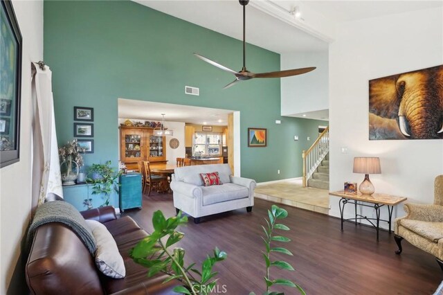 5020 Solitude Ct, Rancho Cucamonga, CA 91737 - living area featuring wood finished floors, a ceiling fan, stairway, and a towering ceiling