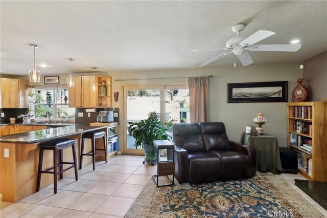 5020 Solitude Ct, Rancho Cucamonga, CA 91737 - living room with ceiling fan, light tile patterned floors, and a textured ceiling