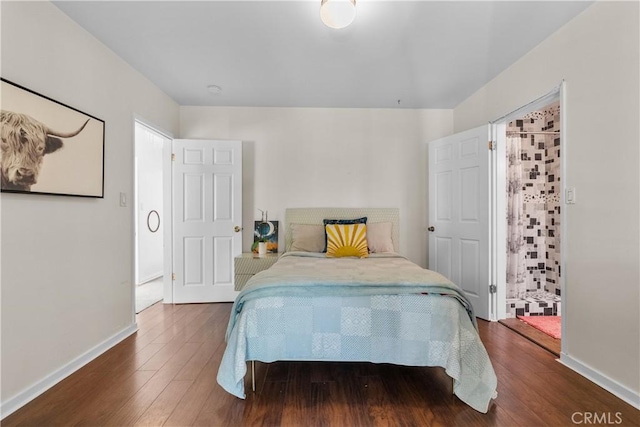 bedroom featuring dark wood finished floors and baseboards