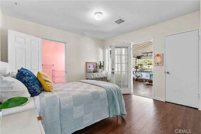 bedroom featuring dark wood-type flooring, french doors, and visible vents