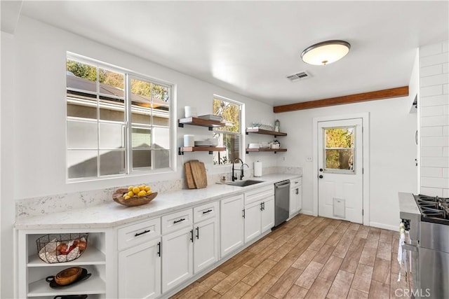 kitchen with open shelves, light countertops, white cabinets, and stainless steel appliances