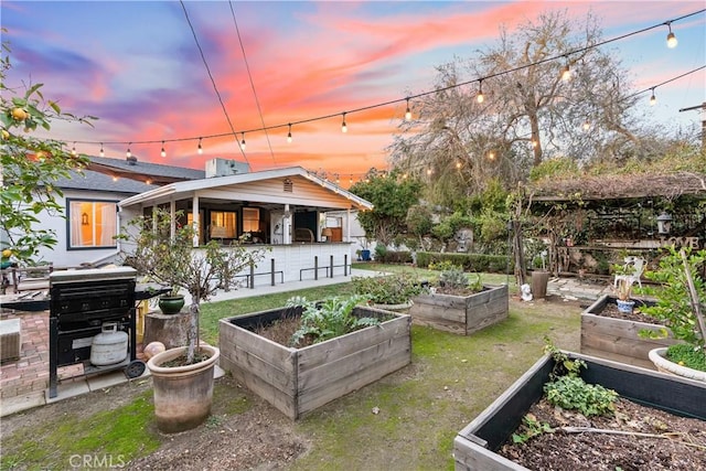 back of property at dusk featuring exterior bar