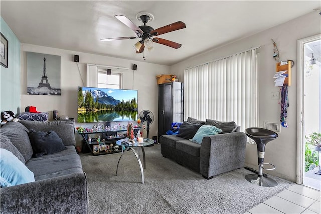 living room featuring light tile patterned floors and ceiling fan