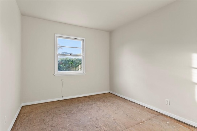 unfurnished room featuring baseboards