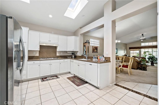 kitchen with stainless steel refrigerator with ice dispenser, light tile patterned floors, open floor plan, white cabinets, and dishwasher