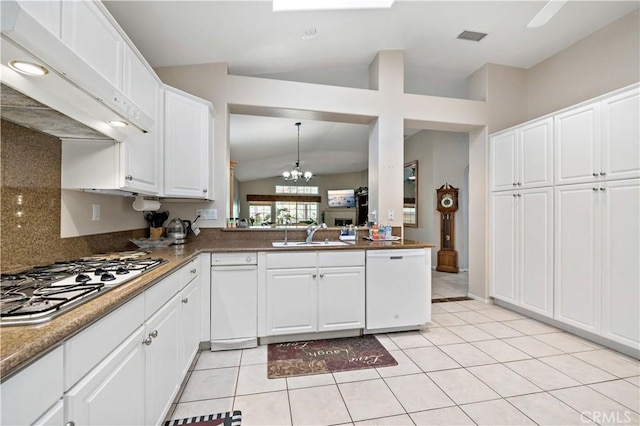 kitchen with stainless steel gas stovetop, white cabinets, dishwasher, and a sink