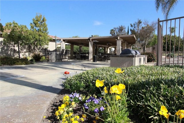 view of community with exterior bar and a patio